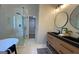 Modern bathroom with double sink vanity, sleek fixtures, and a glass-enclosed shower and tub combo at 219 Maple Creek Chase, Woodstock, GA 30188