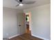 A calming bedroom with neutral paint and wood floors leads to other spaces at 219 Maple Creek Chase, Woodstock, GA 30188