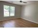 A light-filled bedroom showcasing wood floors and bright windows at 219 Maple Creek Chase, Woodstock, GA 30188