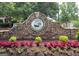 Stone entrance to Parkside at Bradshaw Farm features colorful landscaping at 219 Maple Creek Chase, Woodstock, GA 30188
