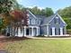 Attractive two-story home with a welcoming front porch and well-maintained landscaping at 219 Maple Creek Chase, Woodstock, GA 30188