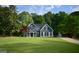 Charming two-story home with a well-manicured lawn and traditional architectural details at 219 Maple Creek Chase, Woodstock, GA 30188