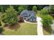 Two-story home features a large front yard, driveway, and well-maintained landscaping at 219 Maple Creek Chase, Woodstock, GA 30188