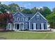 Beautiful two-story home featuring classic design elements, complemented by a lush green lawn at 219 Maple Creek Chase, Woodstock, GA 30188