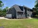 Expansive backyard exterior showcases a well-manicured lawn and mature landscaping at 219 Maple Creek Chase, Woodstock, GA 30188