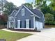 Side view of a home featuring a side-entry garage and complemented by lovely landscaping at 219 Maple Creek Chase, Woodstock, GA 30188