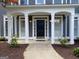 Inviting covered porch with elegant columns, providing a warm welcome to this lovely home at 219 Maple Creek Chase, Woodstock, GA 30188