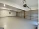Spacious three car garage with epoxy flooring and freshly painted walls at 219 Maple Creek Chase, Woodstock, GA 30188
