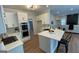 Bright kitchen with white cabinetry, a center island with bar seating, and stainless steel appliances at 219 Maple Creek Chase, Woodstock, GA 30188