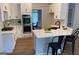 Bright kitchen with white cabinetry, a center island with bar seating, and stainless steel appliances at 219 Maple Creek Chase, Woodstock, GA 30188