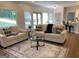 Bright and open living room featuring two sofas, wood floors, and a view to a kitchen with bar stool seating at 219 Maple Creek Chase, Woodstock, GA 30188