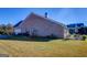 Expansive backyard features a well-kept lawn and patio area with outdoor dining furniture at 3008 Brighton Ct, Conyers, GA 30094