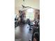 Workout room with vinyl floors, weights, exercise machines, a ceiling fan and arched window at 3008 Brighton Ct, Conyers, GA 30094