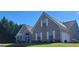 Charming brick home featuring well-maintained landscaping and a manicured lawn at 3008 Brighton Ct, Conyers, GA 30094