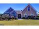 Charming brick home featuring a well-maintained lawn, mature landscaping, and inviting entryway with decorative door at 3008 Brighton Ct, Conyers, GA 30094