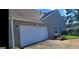 Attached garage with a paved driveway and manicured landscaping at 3008 Brighton Ct, Conyers, GA 30094