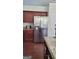 Kitchen with stainless steel refrigerator, dark wood cabinets, and granite countertops at 3008 Brighton Ct, Conyers, GA 30094