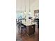 Kitchen island with granite countertops and barstool seating, complemented by stainless steel appliances at 3008 Brighton Ct, Conyers, GA 30094