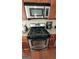 Modern stainless steel gas range with built-in microwave and granite countertops, perfect for cooking enthusiasts at 3008 Brighton Ct, Conyers, GA 30094