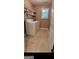 Neat laundry room with a washer, dryer, shelving, tile floor and a window at 3008 Brighton Ct, Conyers, GA 30094