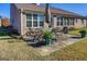 Back patio featuring an outdoor dining set, lush landscaping, and well-maintained lawn at 3008 Brighton Ct, Conyers, GA 30094