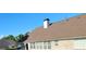 View of the house roof showing a brick facade and bright blue sky at 3008 Brighton Ct, Conyers, GA 30094