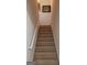 Carpeted staircase with white handrail leading to the upper level of the home at 3008 Brighton Ct, Conyers, GA 30094