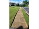 Street view showcasing well-maintained lawns, trees, and sidewalks in a residential neighborhood at 3008 Brighton Ct, Conyers, GA 30094