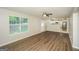 Open living room with hardwood floors, ceiling fan, and large windows that fill the space with natural light at 3587 Oakvale Ave, Decatur, GA 30034
