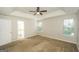 Bright, spacious main bedroom boasts a tray ceiling, ceiling fan, and two large windows, creating a peaceful retreat at 3587 Oakvale Ave, Decatur, GA 30034