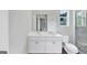 Modern bathroom featuring dual sinks, a marble countertop, and elegant fixtures at 107 Cedar Brook Dr, Canton, GA 30115