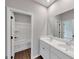 A bathroom featuring double sinks, neutral walls, and a view of the toilet and bath/shower room at 107 Cedar Brook Dr, Canton, GA 30115