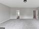 Spacious carpeted bedroom with entryways, gray paint and recessed lighting at 107 Cedar Brook Dr, Canton, GA 30115