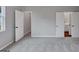 Bedroom with neutral walls, light gray carpet, and multiple doorways leading to various areas of the home at 107 Cedar Brook Dr, Canton, GA 30115