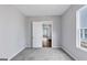 Carpeted bedroom with gray walls and window, a closet and view into the hallway at 107 Cedar Brook Dr, Canton, GA 30115