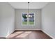 Dining room with wood-look floors and windows overlooking the backyard at 107 Cedar Brook Dr, Canton, GA 30115