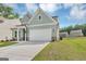 Light blue two-story home boasts a well-manicured lawn, two-car garage, and inviting curb appeal in a suburban setting at 107 Cedar Brook Dr, Canton, GA 30115