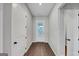 Inviting foyer with wood floors, white trim, and natural light streaming through the glass-paneled front door creating a bright and open space at 107 Cedar Brook Dr, Canton, GA 30115
