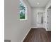 Hallway featuring hardwood floors, neutral walls, and a window providing natural light at 107 Cedar Brook Dr, Canton, GA 30115