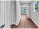 Hallway featuring hardwood floors, neutral walls, and an opening showing more of the house at 107 Cedar Brook Dr, Canton, GA 30115