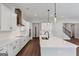 Bright open kitchen with white cabinets, island with sink, and stainless appliances at 107 Cedar Brook Dr, Canton, GA 30115