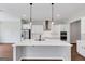Bright kitchen features white cabinets, stainless steel appliances, island with sink, and pendant lighting at 107 Cedar Brook Dr, Canton, GA 30115