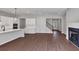 Spacious living room has wood-look flooring, white trim, fireplace, and flows into the open kitchen at 107 Cedar Brook Dr, Canton, GA 30115