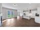 Open-concept living area featuring hardwood floors, a modern kitchen with stainless steel appliances, and large glass doors to the backyard at 107 Cedar Brook Dr, Canton, GA 30115