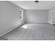 A neutral colored room with light gray carpet and a single window providing natural light at 107 Cedar Brook Dr, Canton, GA 30115