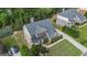 Aerial view of a brick home with a landscaped lawn and driveway at 2750 Brentwood Estates Ct, Cumming, GA 30041