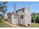 Back view of a house featuring an attached deck, patio, and a well manicured lawn at 2750 Brentwood Estates Ct, Cumming, GA 30041