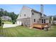 A view of a well-maintained backyard, patio and house showing a combination of brick and siding at 2750 Brentwood Estates Ct, Cumming, GA 30041
