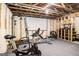 Basement area with workout equipment, exposed beams, and finished carpet at 2750 Brentwood Estates Ct, Cumming, GA 30041