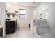Elegant bathroom with a glass shower, a tub, and a dark vanity with tile floors at 2750 Brentwood Estates Ct, Cumming, GA 30041